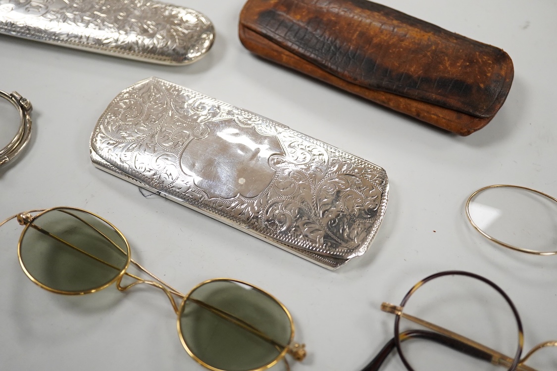 An Edwardian engraved silver spectacle case, by Boots Pure Drug Company, Chester, 1903, one other engraved silver spectacles case, hallmarks rubbed, a pair of 830 standard white metal and niello lorgnettes, two other pai